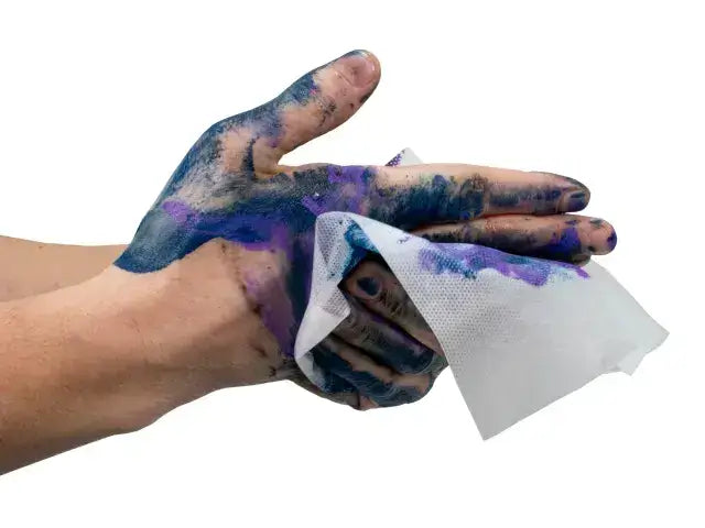 Person cleaning hands covered in paint with a Heavy-duty Trade Wipe, showing its effectiveness on tough stains.